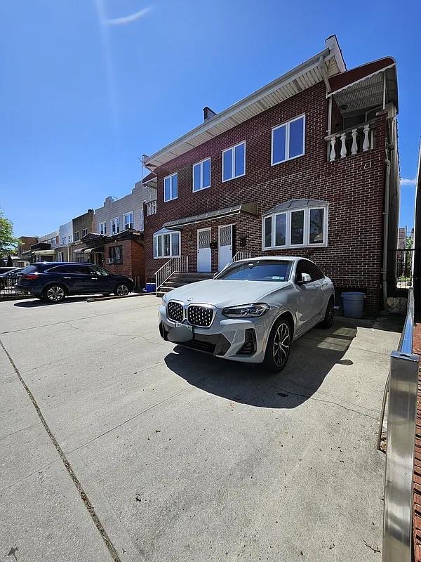 view of property with brick siding and a residential view