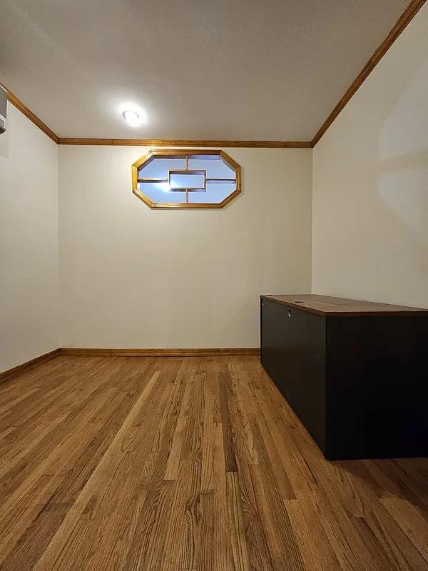 bonus room featuring wood finished floors and baseboards