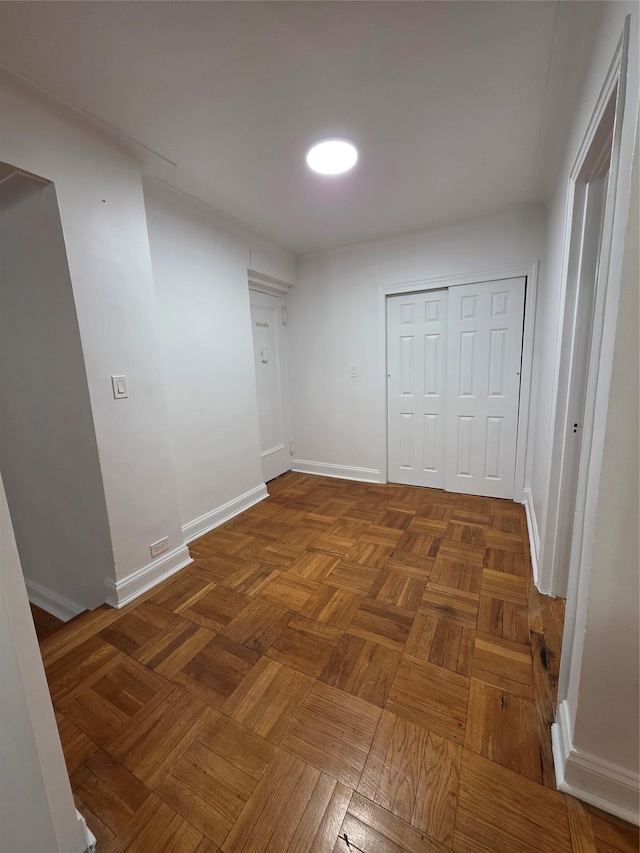 unfurnished bedroom with baseboards and a closet