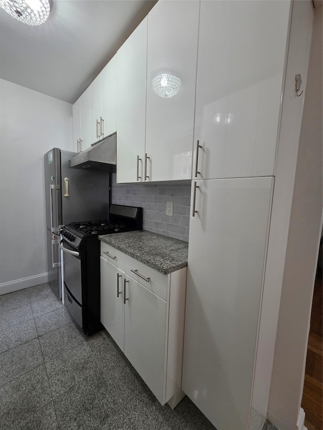 kitchen featuring black gas range oven, under cabinet range hood, granite floors, backsplash, and white cabinetry
