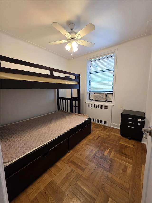 bedroom featuring radiator heating unit, ceiling fan, and cooling unit