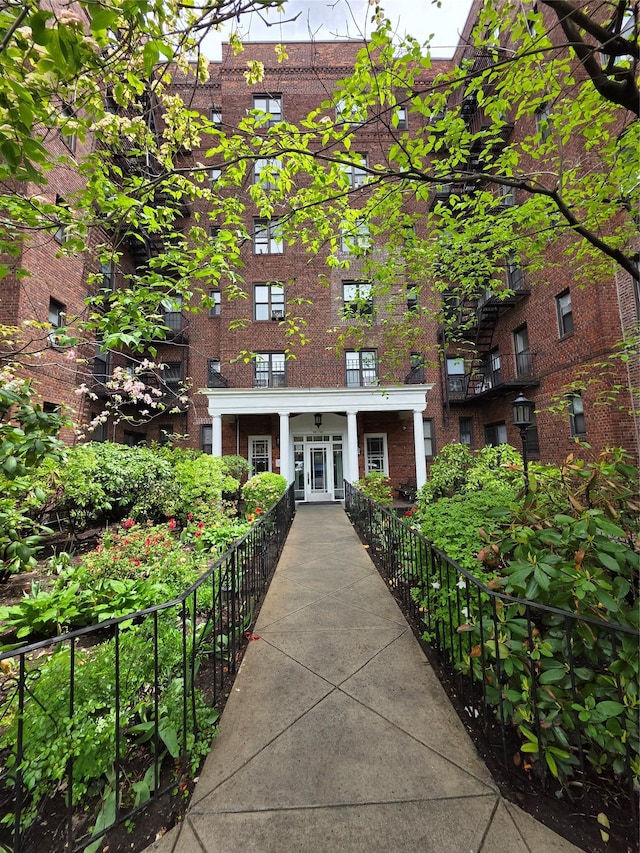 entrance to property with brick siding and a porch