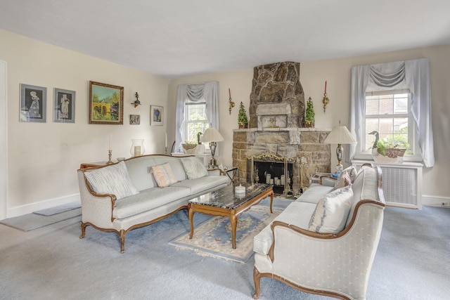 living area with a fireplace, carpet, and baseboards