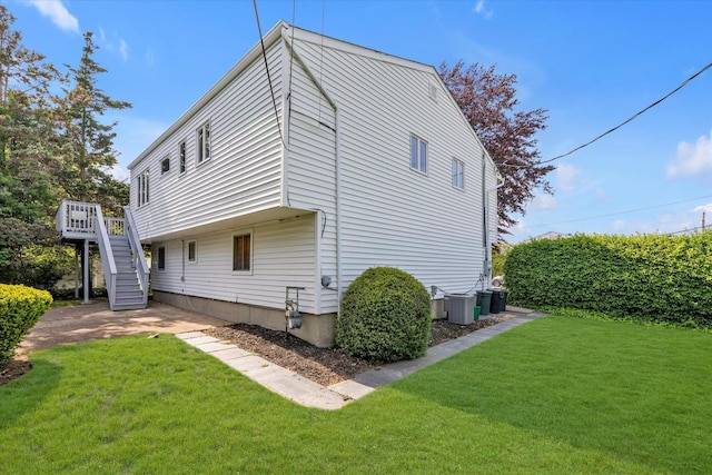 1692 N Gate, Merrick, NY 11566 - back of house with stairway, a yard, central AC unit, and a deck
