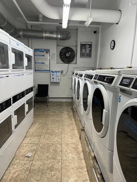 communal laundry room featuring stacked washer and clothes dryer and washing machine and dryer