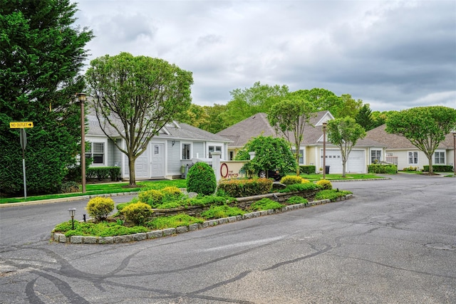 7 White Oak Ct Unit 7, Coram, NY 11727 - view of property hidden behind natural elements featuring a residential view and driveway