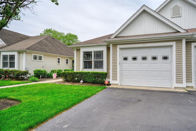 7 White Oak Ct Unit 7, Coram, NY 11727 - view of front facade featuring board and batten siding, an attached garage, a front yard, and asphalt driveway
