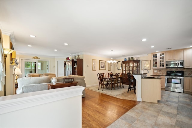 7 White Oak Ct Unit 7, Coram, NY 11727 - kitchen with stainless steel appliances, dark countertops, open floor plan, glass insert cabinets, and a chandelier