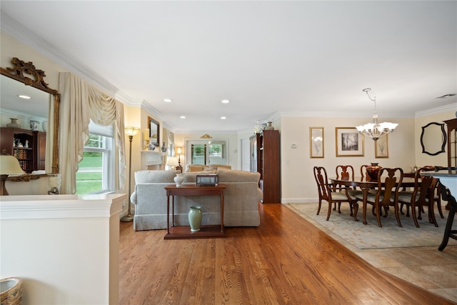 7 White Oak Ct Unit 7, Coram, NY 11727 - living area with healthy amount of natural light, a chandelier, ornamental molding, wood finished floors, and baseboards