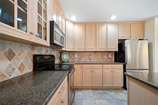 7 White Oak Ct Unit 7, Coram, NY 11727 - kitchen featuring stainless steel appliances, tasteful backsplash, dark stone counters, recessed lighting, and glass insert cabinets