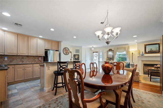 7 White Oak Ct Unit 7, Coram, NY 11727 - dining room featuring ornamental molding, a chandelier, recessed lighting, and a lit fireplace