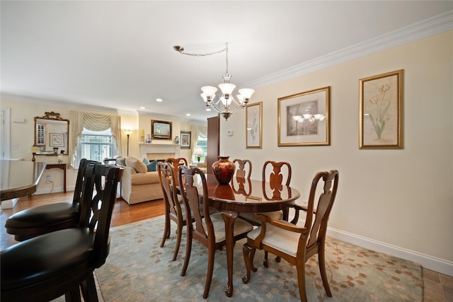 7 White Oak Ct Unit 7, Coram, NY 11727 - dining space featuring crown molding, a chandelier, baseboards, wood finished floors, and a fireplace
