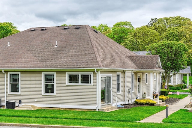7 White Oak Ct Unit 7, Coram, NY 11727 - rear view of property with a lawn, central air condition unit, and roof with shingles