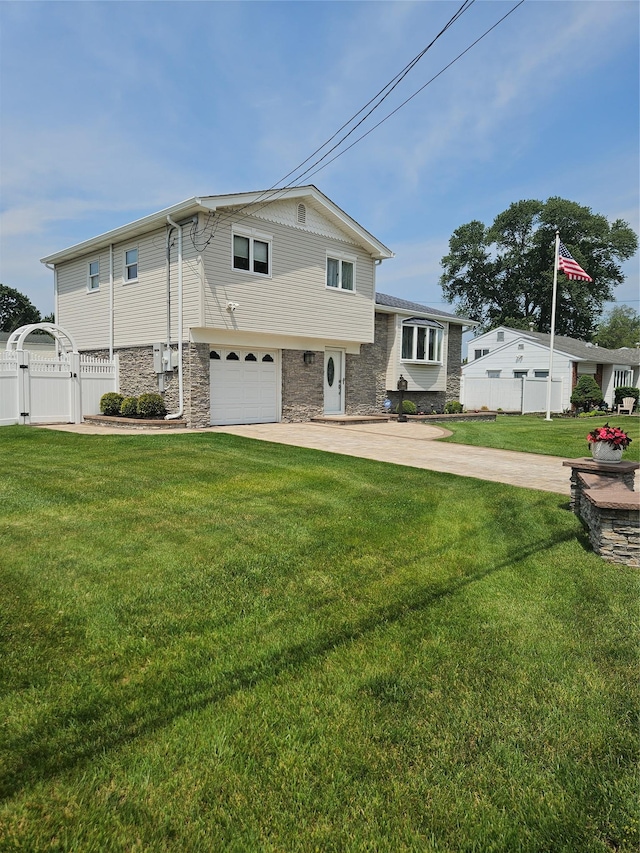 336 W 17th St, Deer Park, NY 11729 - view of front of home with stone siding, a gate, a garage, and driveway