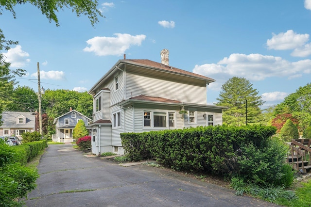 view of side of home featuring a chimney