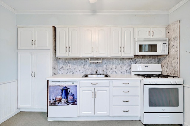 kitchen with white appliances, a sink, crown molding, white cabinets, and light countertops