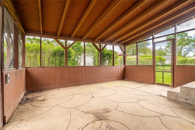 unfurnished sunroom featuring vaulted ceiling