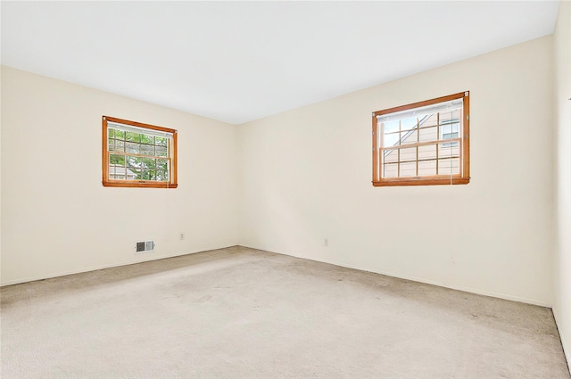 empty room with carpet floors and baseboards