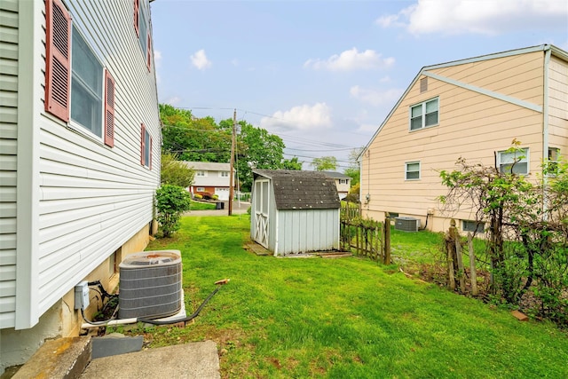 view of yard featuring a storage unit, cooling unit, and an outdoor structure