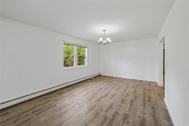 54 Oakdale Ave, Selden, NY 11784 - unfurnished room with a baseboard heating unit, a chandelier, wood finished floors, and baseboards
