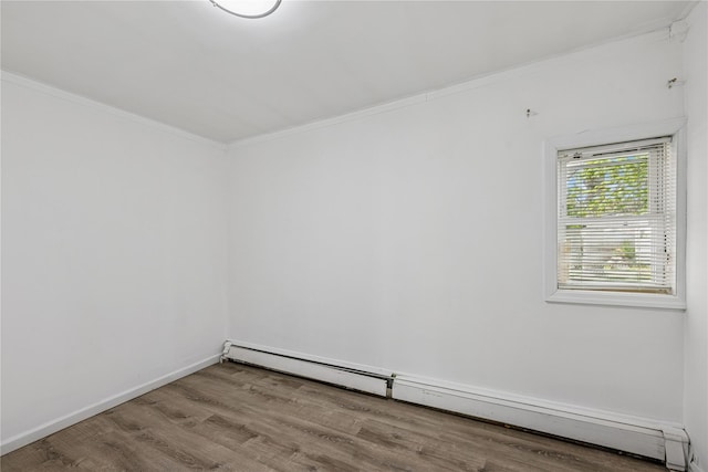 54 Oakdale Ave, Selden, NY 11784 - empty room with baseboard heating, wood finished floors, ornamental molding, and baseboards