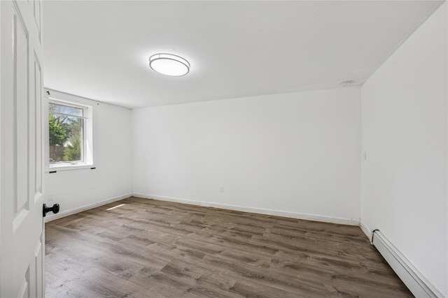 54 Oakdale Ave, Selden, NY 11784 - unfurnished room with a baseboard radiator, wood finished floors, and baseboards