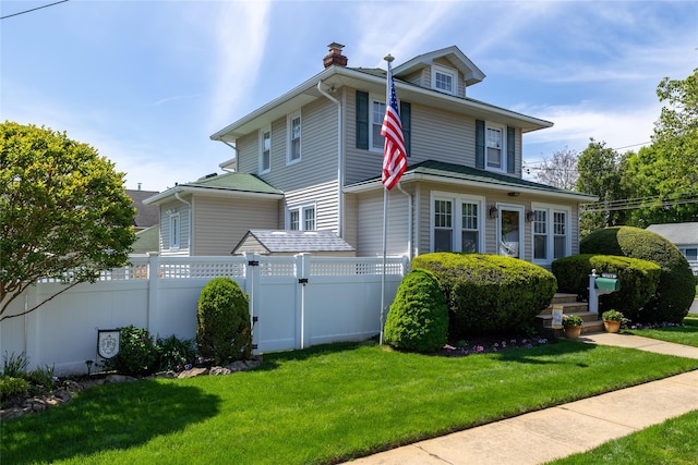 traditional style home with a chimney and a gate