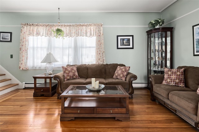 living area featuring baseboard heating, plenty of natural light, and wood finished floors