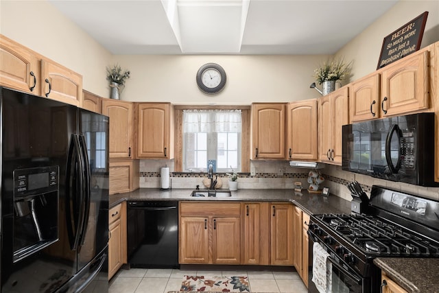 kitchen featuring black appliances, a sink, backsplash, dark countertops, and light tile patterned floors