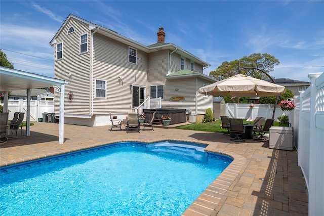 view of pool featuring a hot tub, a patio area, outdoor dining space, and a fenced backyard
