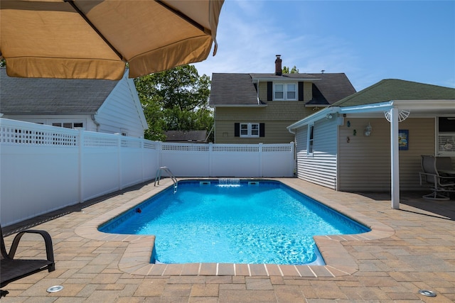 view of swimming pool featuring a fenced backyard and a patio area