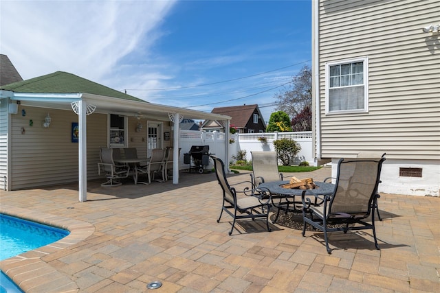 view of patio / terrace featuring fence, an outdoor fire pit, and outdoor dining area