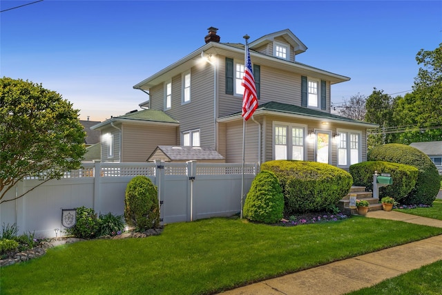 traditional style home featuring a chimney and a gate