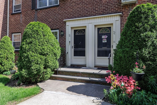 property entrance featuring brick siding