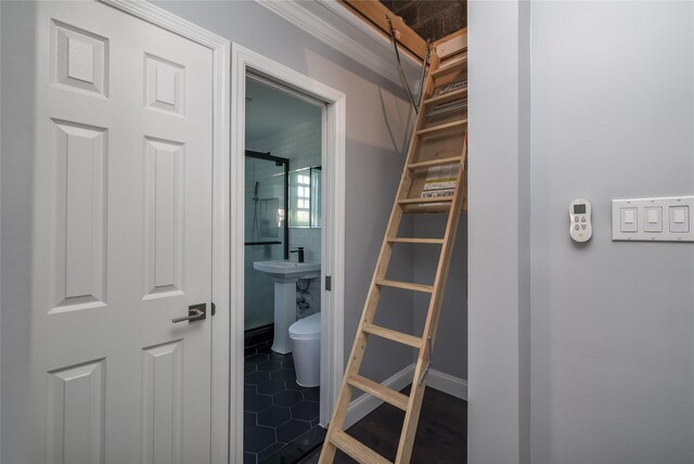 bathroom with ornamental molding, tile patterned floors, toilet, and a sink