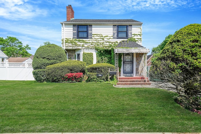 66 Elmwood Ave, Hempstead, NY 11550 - view of front facade featuring a chimney and stone siding