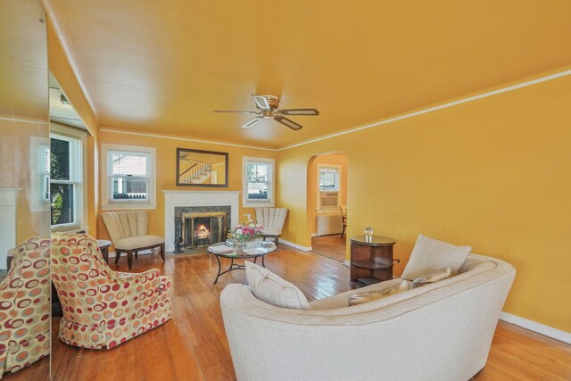 66 Elmwood Ave, Hempstead, NY 11550 - living area featuring hardwood / wood-style flooring, arched walkways, a fireplace, and a ceiling fan