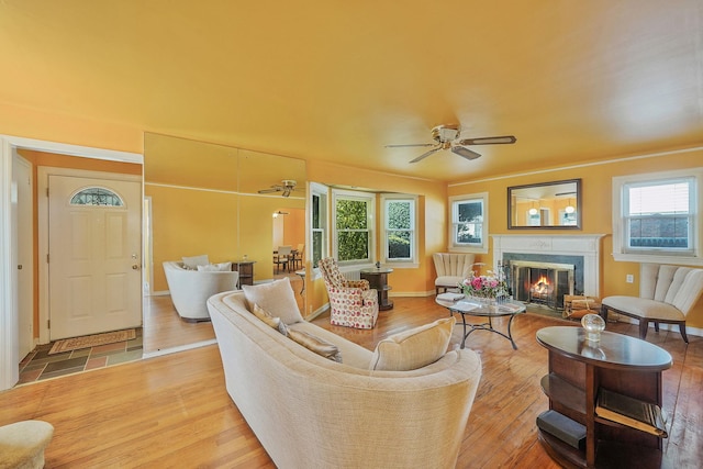66 Elmwood Ave, Hempstead, NY 11550 - living room with light wood-style floors, a high end fireplace, a ceiling fan, and baseboards