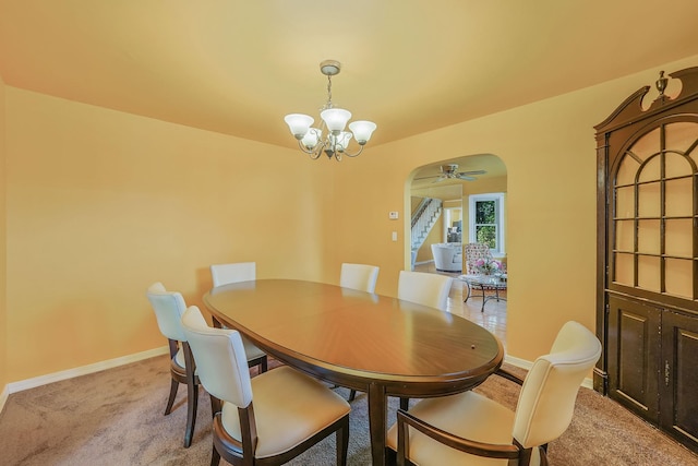 66 Elmwood Ave, Hempstead, NY 11550 - dining room with arched walkways, a chandelier, light colored carpet, and baseboards