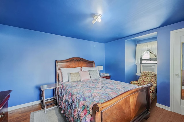 66 Elmwood Ave, Hempstead, NY 11550 - bedroom with baseboards, wood finished floors, and cooling unit