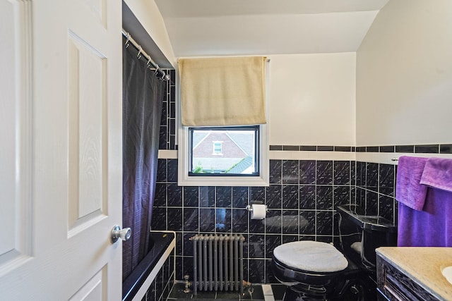 66 Elmwood Ave, Hempstead, NY 11550 - bathroom featuring radiator, tile walls, toilet, vanity, and tiled shower / bath