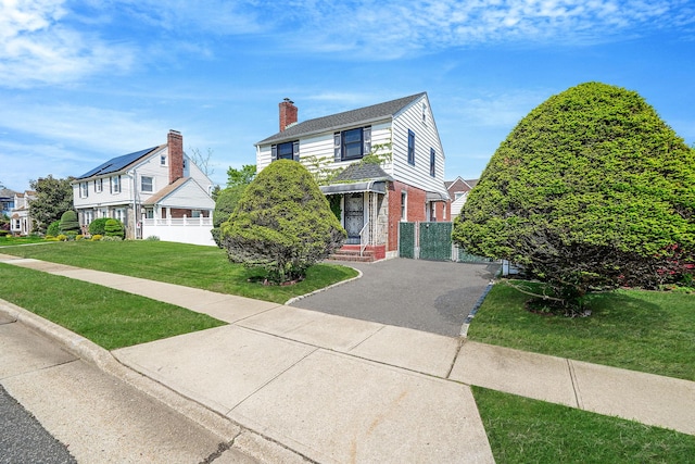 66 Elmwood Ave, Hempstead, NY 11550 - view of front facade with brick siding and a chimney