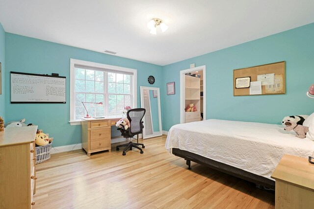 1988 Beekman Ct, Yorktown Heights, NY 10598 - bedroom featuring wood finished floors, baseboards, and a walk in closet
