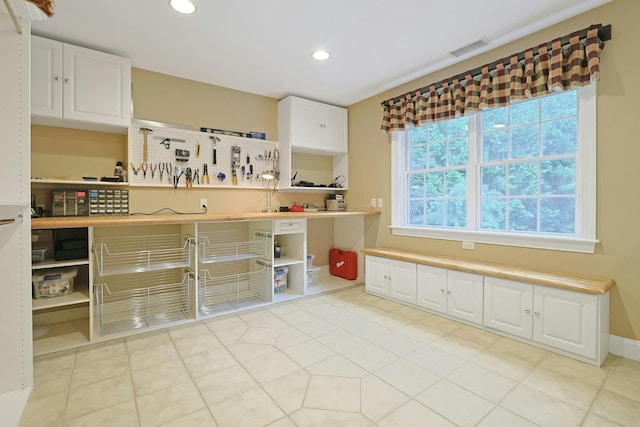 1988 Beekman Ct, Yorktown Heights, NY 10598 - kitchen with open shelves, white cabinets, recessed lighting, light countertops, and light tile patterned flooring