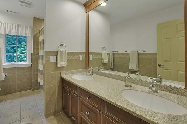 1988 Beekman Ct, Yorktown Heights, NY 10598 - bathroom with tile walls, tile patterned flooring, double vanity, a wainscoted wall, and tiled shower
