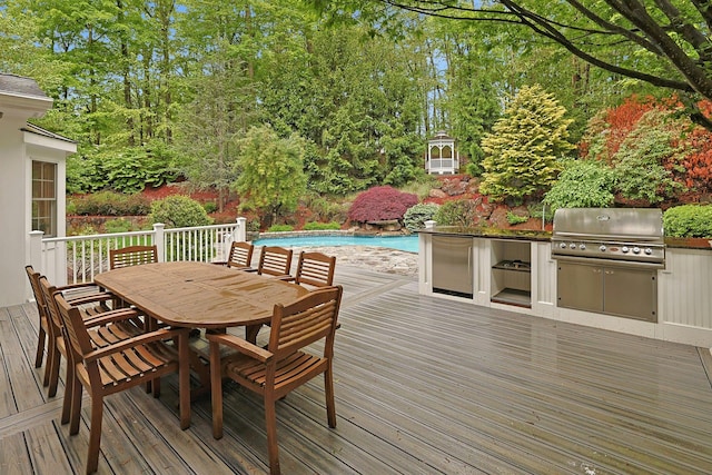 1988 Beekman Ct, Yorktown Heights, NY 10598 - deck featuring grilling area, outdoor dining space, an outdoor pool, and an outdoor kitchen