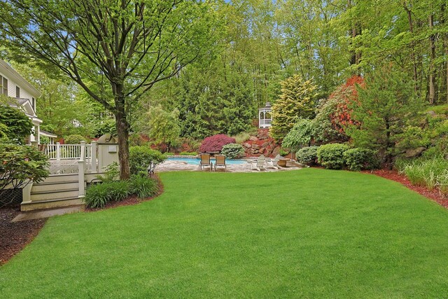 1988 Beekman Ct, Yorktown Heights, NY 10598 - view of grassy yard with a wooden deck and an outdoor pool