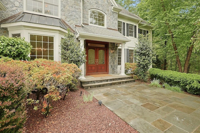 1988 Beekman Ct, Yorktown Heights, NY 10598 - entrance to property featuring stone siding, a standing seam roof, and a shingled roof