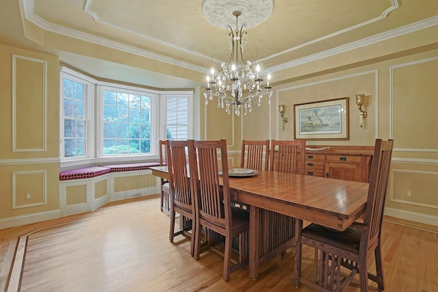 1988 Beekman Ct, Yorktown Heights, NY 10598 - dining room with a decorative wall, light wood-style flooring, a chandelier, a tray ceiling, and crown molding
