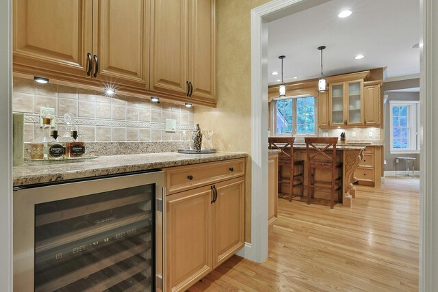 1988 Beekman Ct, Yorktown Heights, NY 10598 - indoor bar featuring beverage cooler, light wood finished floors, decorative backsplash, pendant lighting, and recessed lighting